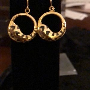 Gold 1 inch hoop earrings with heart cutouts.